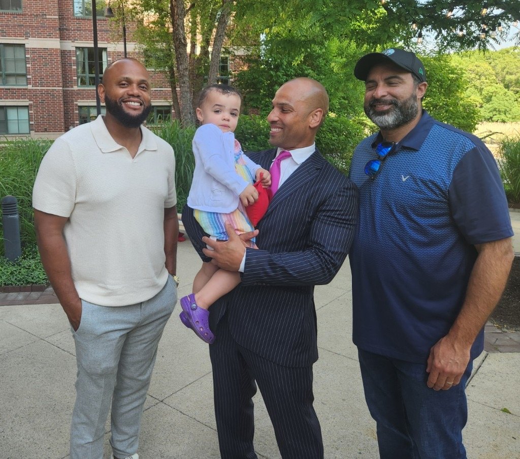 Clinton Graham with friends and a child in the community