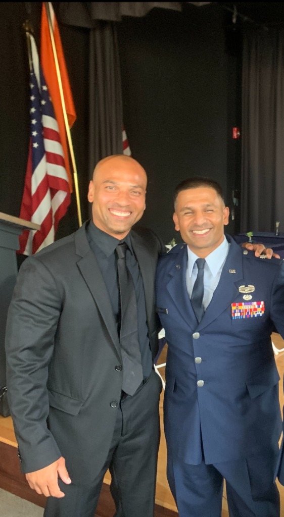 Clinton Graham with a service member in uniform