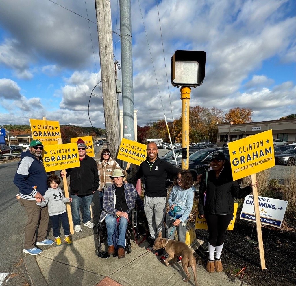 Clinton Graham with supporters holding campaign signs